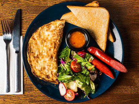 omelet with sausage and saladの写真素材