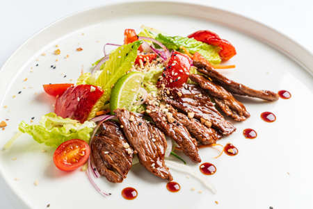 beef with grilled vegetables on the white plateの写真素材