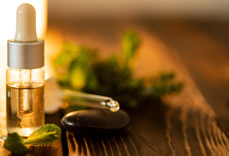 Bottle of essential oil with fresh herbal
