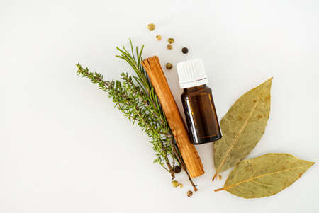Bottle of essential oil with herbs and spicesの写真素材