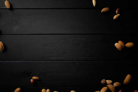 nuts on the wooden black backgroundの写真素材