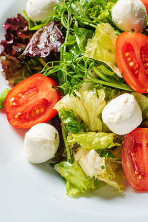 fresh salad with mozzarella and vegetablesの写真素材