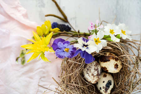 Easter nest with spring flowersの写真素材