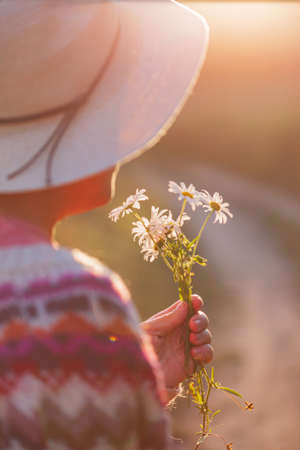woman with flowers outdoor, cottage core styleの写真素材
