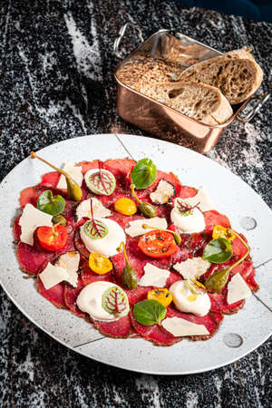 beef carpaccio with cheese and vegetablesの写真素材