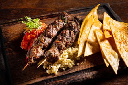 Barbecued kofta - kebeb with vegetables on a plateの写真素材