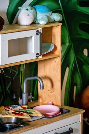 Play in the kitchen. Wooden toys for cooking on the kitchen table.の写真素材