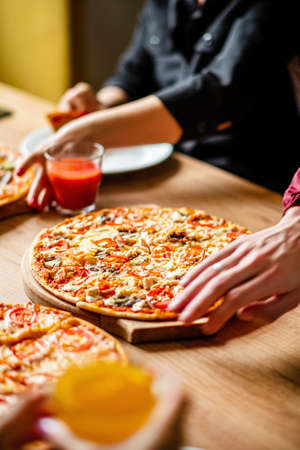 Group of people eating pizza.の写真素材