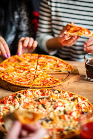 Group of people eating pizza.の写真素材