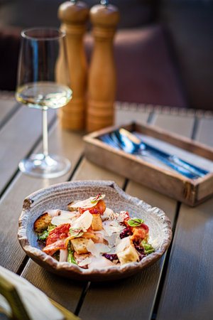 Caesar salad with crispy bread and bacon