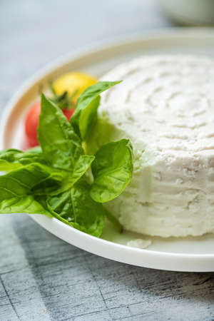fresh ricotta with basil and tomatoの写真素材