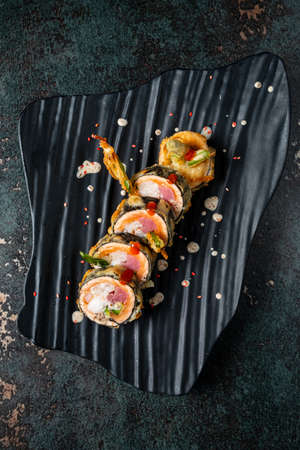 tempura sushii on the black plateの写真素材