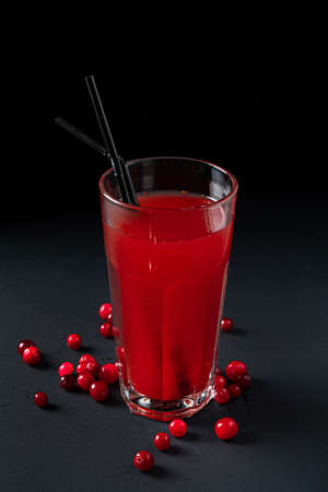 Glass of cranberry juice on black backgroundの写真素材