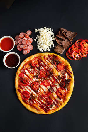 Ingredients for pizza on the black backgroundの写真素材