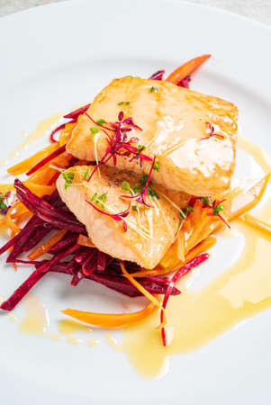 salmon steak with vegetables and sauceの写真素材