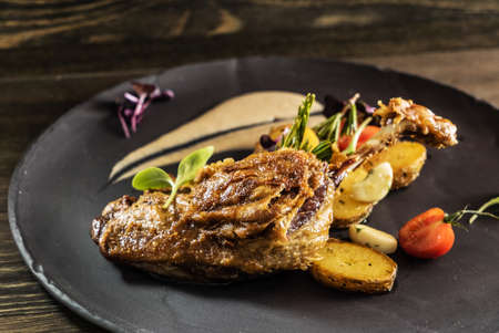 Roasted duck legs with potato and sauce.の写真素材