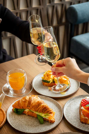 woman drinking champagne in the restaurantの写真素材