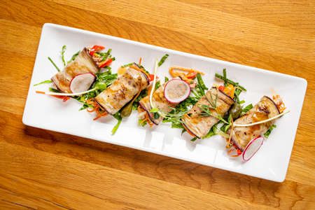 eggplant rolls with vegetables and sauceの写真素材