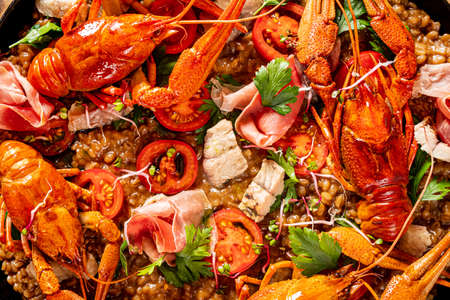 Catalan paella with shrimp and blue fideua on a rustic wooden background.の写真素材