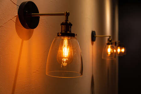 Vintage golden light bulb with shine light on dark background.の写真素材