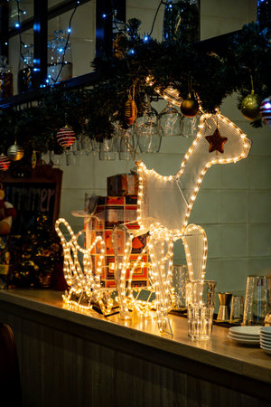 Deer and reindeer on sleigh in cold winter season yard.の写真素材
