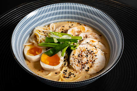 Japanese ramen soup with chicken, egg and green onionの写真素材