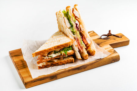 Sandwich with ham, cheese, tomatoes, lettuce, and toasted bread