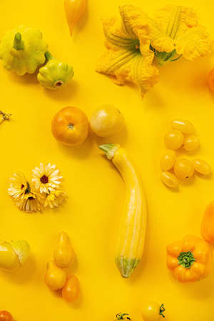 Yellow vegetables on the yellow backgroundの写真素材