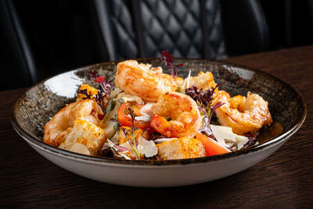 salad with shrimps on wooden backgroundの写真素材