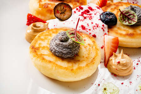 gourmet cottage cheese pancakes with sauceの写真素材