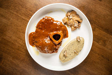 Ossobuco - slow cooked food on a rustic wooden table.の写真素材