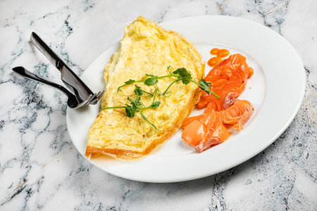 omelet with salmon on the white plateの写真素材