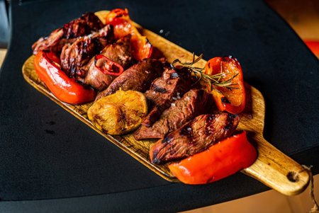 grilled pork with vegetables on wooden board