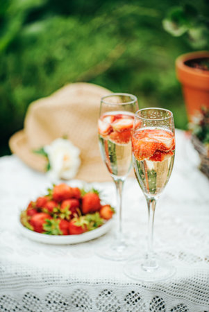 champagne with strawberries in the gardenの写真素材