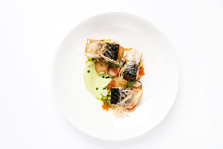 plate with delicious grilled mackerel with vegetables and green pea pureeの写真素材