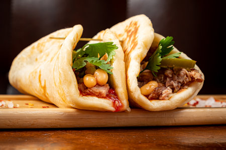 Mexican food quesadillas with chicken and cheese served on rustic wooden chopping boardの写真素材