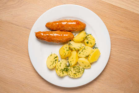 cutlet with baked potato on wooden backgroundの写真素材