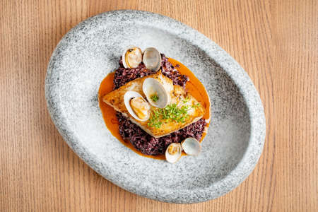 Halibut steak with vegetables and sauceの写真素材