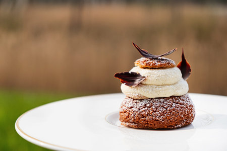 tasty cake with vanilla cream on white plate