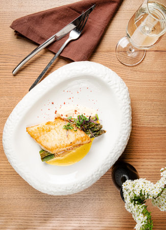Fried fish fillet. Cod with sauce and herbs