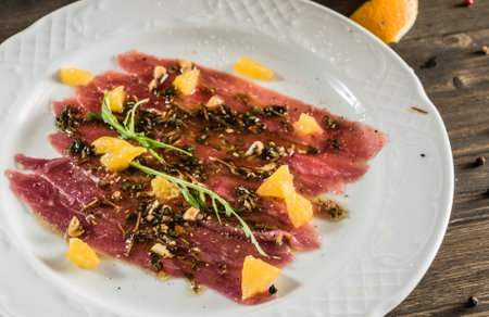 duck carpaccio with orange and pestoの写真素材