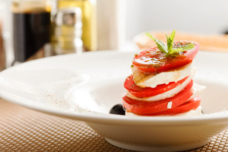 Caprese Salad on whtie plateの写真素材