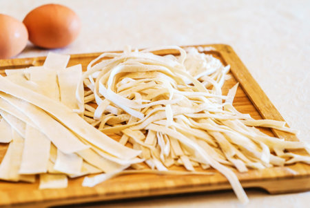 homemade noodles from dough on a boardの写真素材