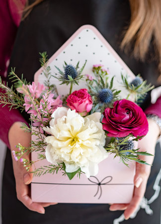 Bouquet of flowers in the hands of a floristの写真素材