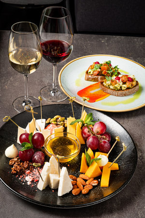 cheese plate with fruits and wineの写真素材