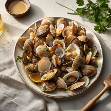 Delicious clams with garlic sauce on white table, closeupの写真素材