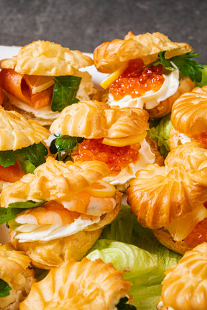 Different light snack on wooden tray on wedding partyの写真素材