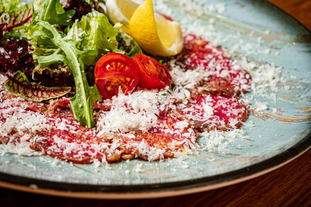 carpaccio meat with parmesan cheese and arugulaの写真素材