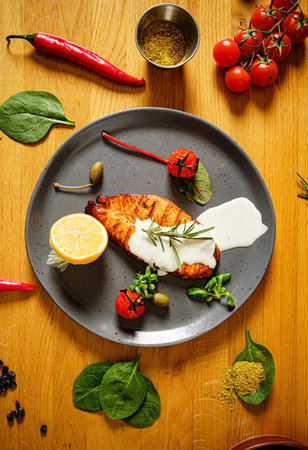 salmon steak with vegetales and sauceの写真素材