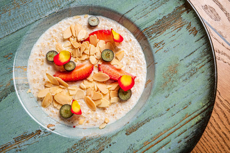 Oatmeal porridge with strawberries and almondの写真素材